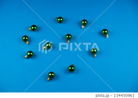 Green christmas balls on a blue background. Green christmas balls on a blue background. 134450961