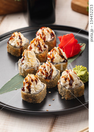 Crispy tempura sushi rolls with sauce 134452253