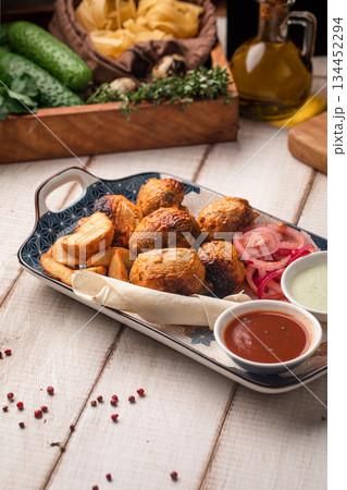 Grilled champignon mushroom skewers with sauce 134452294