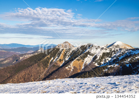 Snow-capped mountain range under a blue sky. The Mala Fatra national park in northwest of Slovakia, Europe. Snow-capped mountain range under a blue sky. The Mala Fatra national park in northwest of Slovakia, Europe. 134454352
