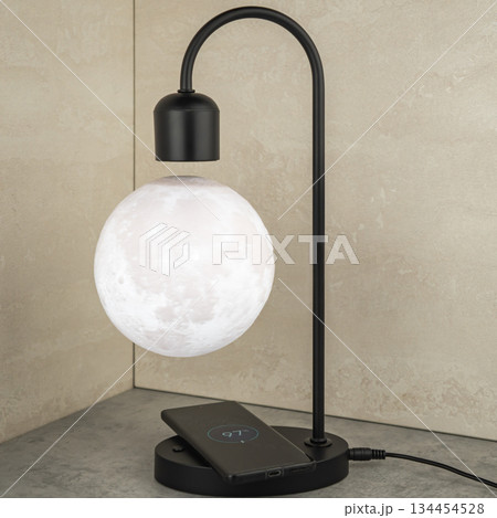 The magnetic Luna lamp rotates in the air, imitating the natural relief of the moon. 134454528