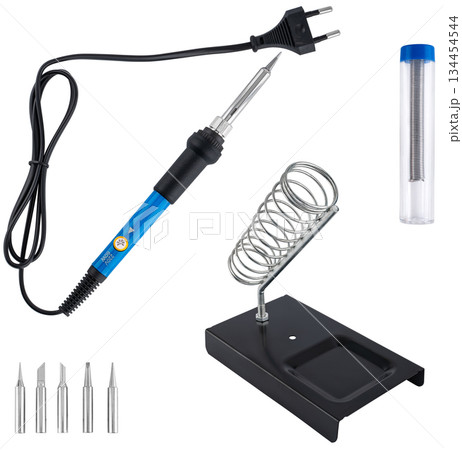 Compact soldering iron with stand, set of tips, and solder, on a white background in insulation. Compact soldering iron with stand, set of tips, and solder, on a white background in insulation. 134454544