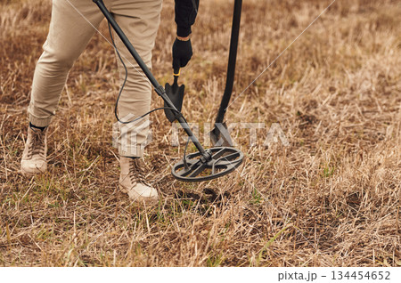 Sensitive sensor, searching. Man is with metal detector in the field Sensitive sensor, searching. Man is with metal detector in the field 134454652