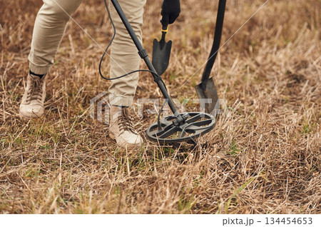Sensitive sensor, searching. Man is with metal detector in the field Sensitive sensor, searching. Man is with metal detector in the field 134454653