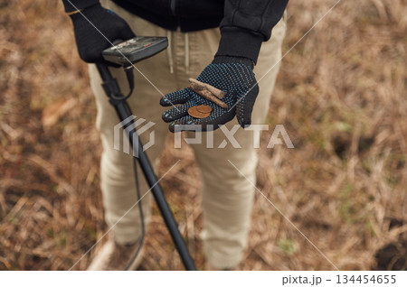 Old bullet, rusty material. Man is with metal detector in the field Old bullet, rusty material. Man is with metal detector in the field 134454655