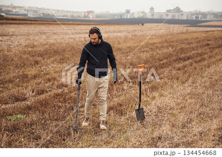In the field. Man is with metal detector In the field. Man is with metal detector 134454668