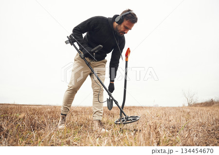 In the field. Man is with metal detector In the field. Man is with metal detector 134454670