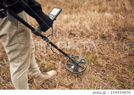 Information on the display. Man is with metal detector in the field 134454676