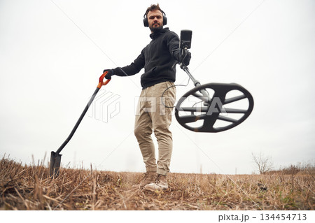 View from below. Man is with metal detector in the field View from below. Man is with metal detector in the field 134454713