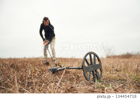 Digging the hole. Man is with metal detector in the field Digging the hole. Man is with metal detector in the field 134454718