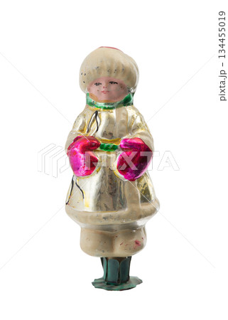 Vintage glass Christmas ornament shaped as a winter child in mittens, isolated on white. 134455019
