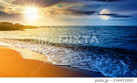 panoramic view of sand beach landscape. day and night time change concept. summer solstice season at the sea with sun and moon on sky. beautiful seaside with calm water. wide coast travel banner panoramic view of sand beach landscape. day and night time change concept. summer solstice season at the sea with sun and moon on sky. beautiful seaside with calm water. wide coast travel banner 134455093