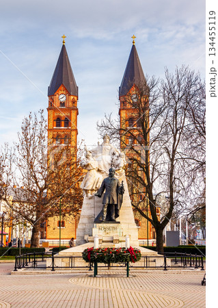nyiregyhaza, eger, hungary - 07 dec 2014: catholic co-cathedral of our lady of hungary and fountain on kossuth square. beautiful urban landscape of nyiregyhaza before christmas under blue sky nyiregyhaza, eger, hungary - 07 dec 2014: catholic co-cathedral of our lady of hungary and fountain on kossuth square. beautiful urban landscape of nyiregyhaza before christmas under blue sky 134455119