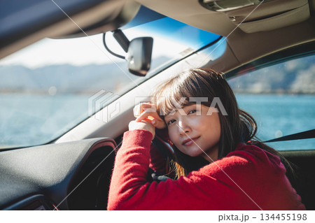 晴れた日に車を運転する若いロングヘアの女性 134455198