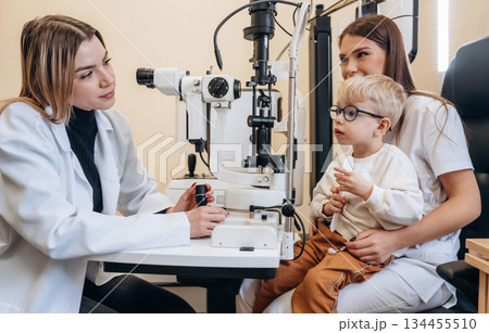 Mother with her son are in the clinic, checking vision 134455510