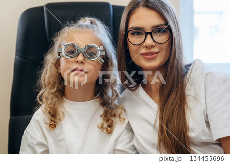 Little girl at the ophthalmologist clinic with doctor 134455696