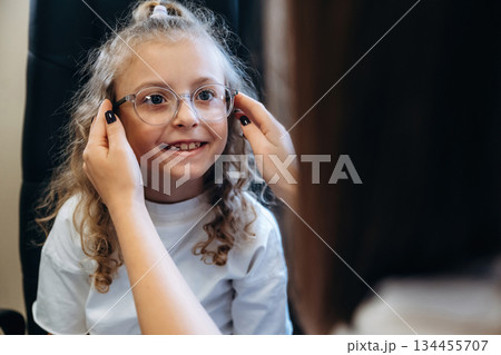 Smiling, new glasses. Little girl at the ophthalmologist clinic with doctor Smiling, new glasses. Little girl at the ophthalmologist clinic with doctor 134455707