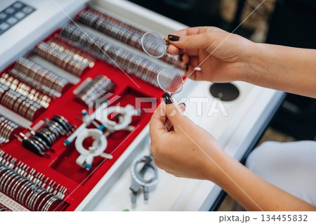 Bunch of objects. Ophthalmologist is picking different lenses that are in the kit 134455832