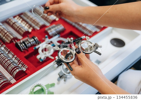 Bunch of objects. Ophthalmologist is picking different lenses that are in the kit 134455836