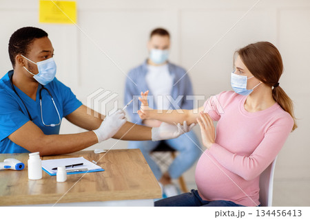 Scared pregnant woman refusing coronavirus vaccine injection at clinic. Expectant lady afraid of making covid-19 immunization, opposing vaccination. Healthcare and medicine concept Scared pregnant woman refusing coronavirus vaccine injection at clinic. Expectant lady afraid of making covid-19 immunization, opposing vaccination. Healthcare and medicine concept 134456413