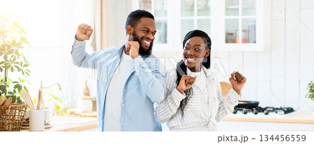 Home Date. Portrait Of Joyful Black Couple Dancing In Kitchen After Romantic Lunch, Cheerful African American Spouses Drinking Red Wine And Having Fun, Enjoying Spending Time Together, Free Space 134456559