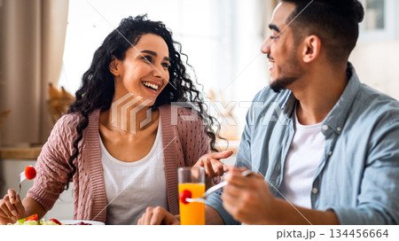 Morning Meal. Romantic Arab Couple Eating Breakfast, Chatting And Laughing In Kitchen, Happy Millennial Middle Eastern Spouses Enjoying Tasty Food, Having Fun At Home Together, Closeup Shot Morning Meal. Romantic Arab Couple Eating Breakfast, Chatting And Laughing In Kitchen, Happy Millennial Middle Eastern Spouses Enjoying Tasty Food, Having Fun At Home Together, Closeup Shot 134456664