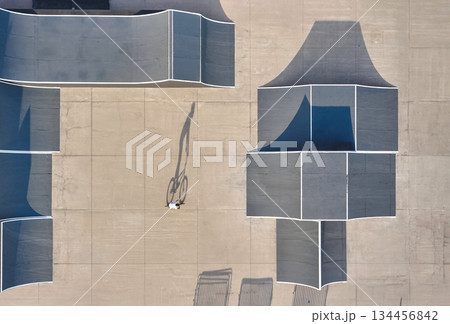 Bmx biker riding concrete skatepark aerial top view 134456842