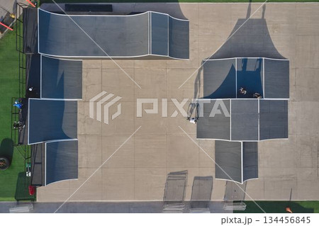 Skatepark aerial view with bmx riders on ramps Skatepark aerial view with bmx riders on ramps 134456845