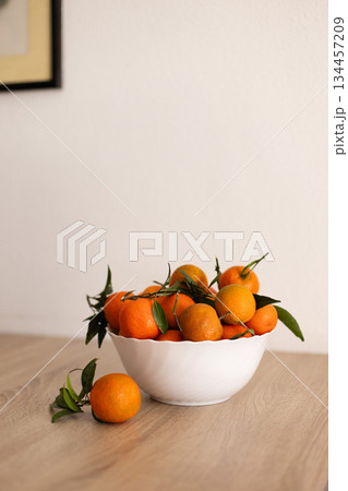 Full bowl of fresh tangerine on a wooden table. Full bowl of fresh tangerine on a wooden table. 134457209