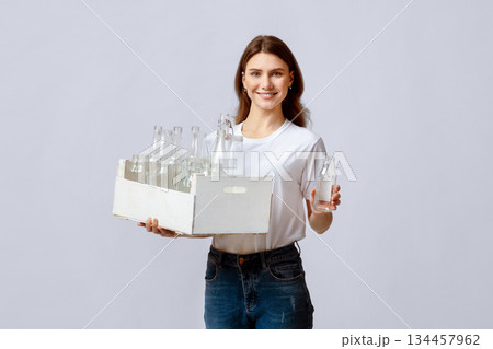 Happy Young Woman Collecting Garbage For Sorting, Holding Container With Empty Glass Bottles For Reuse, Smiling Millennial Lady Holding Wooden Box With Waste Materials For Recycling, Copy Space 134457962