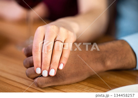 She Said Yes. Closeup Shot Of Female Hand With Engagement Ring Holding Black Boyfriend's Hand During Romantic Date Dinner In Restaurant, Couple Celebrating Emgagement, Cropped Image 134458257