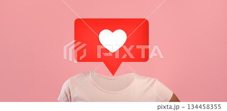 A unique design features a red heart icon inside a speech bubble over human body, using a pink background to symbolize social media interactions. A unique design features a red heart icon inside a speech bubble over human body, using a pink background to symbolize social media interactions. 134458355