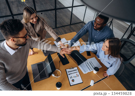 Supporting each other, team is together. Professional workers are in the modern office 134459828