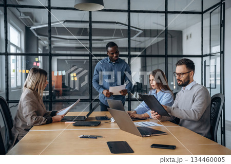 Business conception. Professional workers are in the modern office together 134460005