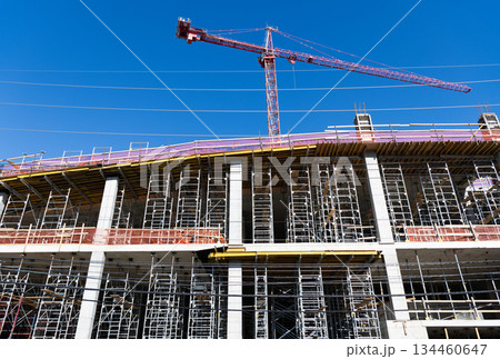 Building and construction. Hoisting crane. Construction at building site with crane. Construction crane at building area. Construction site with building crane. Industrial area. Site inspection Building and construction. Hoisting crane. Construction at building site with crane. Construction crane at building area. Construction site with building crane. Industrial area. Site inspection 134460647