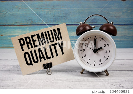 Premium Quality text written on paper card with alarm clock on wooden background 134460921