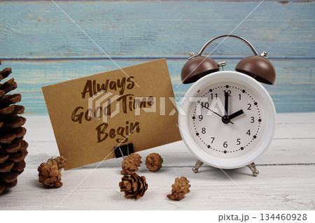 It's Always a Good Time To Begin! text written on paper card with alarm clock and pine cones decoration on wooden background 134460928