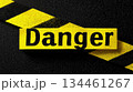 Warning sign indicating danger with bold lettering on a dark surface, highlighting safety concerns in a cautionary context 134461267
