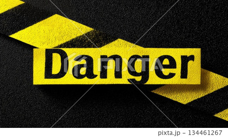Warning sign indicating danger with bold lettering on a dark surface, highlighting safety concerns in a cautionary context 134461267