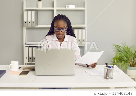 African american business woman accountant working on a laptop at office. African american business woman accountant working on a laptop at office. 134462148