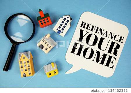 Refinance Your Home text with house models on blue background 134462351