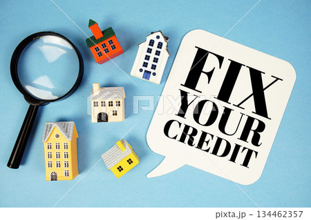 Fix Your Credit text with house models on blue background Fix Your Credit text with house models on blue background 134462357