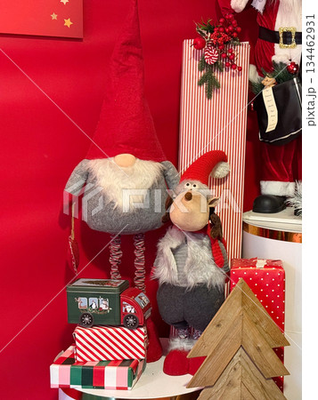 Christmas decor scene with gnomes, gifts and festive ornaments. Cozy holiday interior, winter celebration and playful seasonal styling. Christmas decor scene with gnomes, gifts and festive ornaments. Cozy holiday interior, winter celebration and playful seasonal styling. 134462931