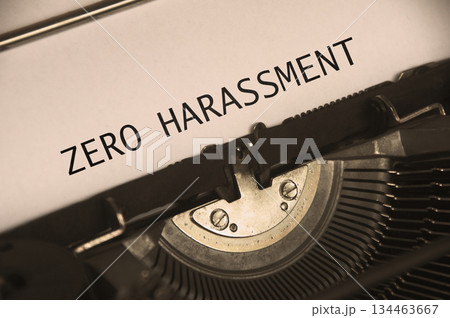 Side view of Zero Harassment text on an old typewriter in vintage color. 134463667