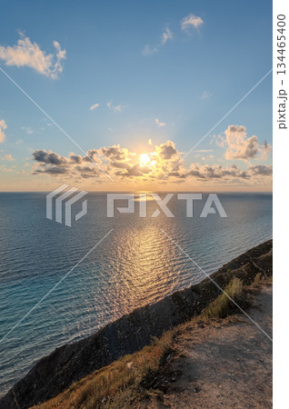 High mountain slopes to the Black Sea coast in Anapa, Russia. Coastline in sunset, beautiful sea scenery. Anapa coast landscape, high cliff High mountain slopes to the Black Sea coast in Anapa, Russia. Coastline in sunset, beautiful sea scenery. Anapa coast landscape, high cliff 134465400