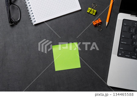 Office supplies and laptop on black leather workspace, top view with copy space 134465588