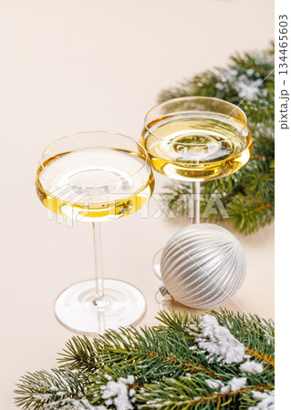 Champagne glasses and snowy fir branches Champagne glasses and snowy fir branches 134465603