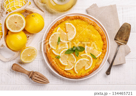 Delicious lemon tart with golden crust and smooth, glossy lemon filling Delicious lemon tart with golden crust and smooth, glossy lemon filling 134465721