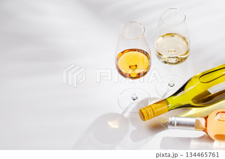 Different wine bottles and glasses on white background Different wine bottles and glasses on white background 134465761