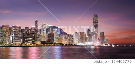 Hong Kong city skyline at sunset with glowing sky and skyscrapers Hong Kong city skyline at sunset with glowing sky and skyscrapers 134465776